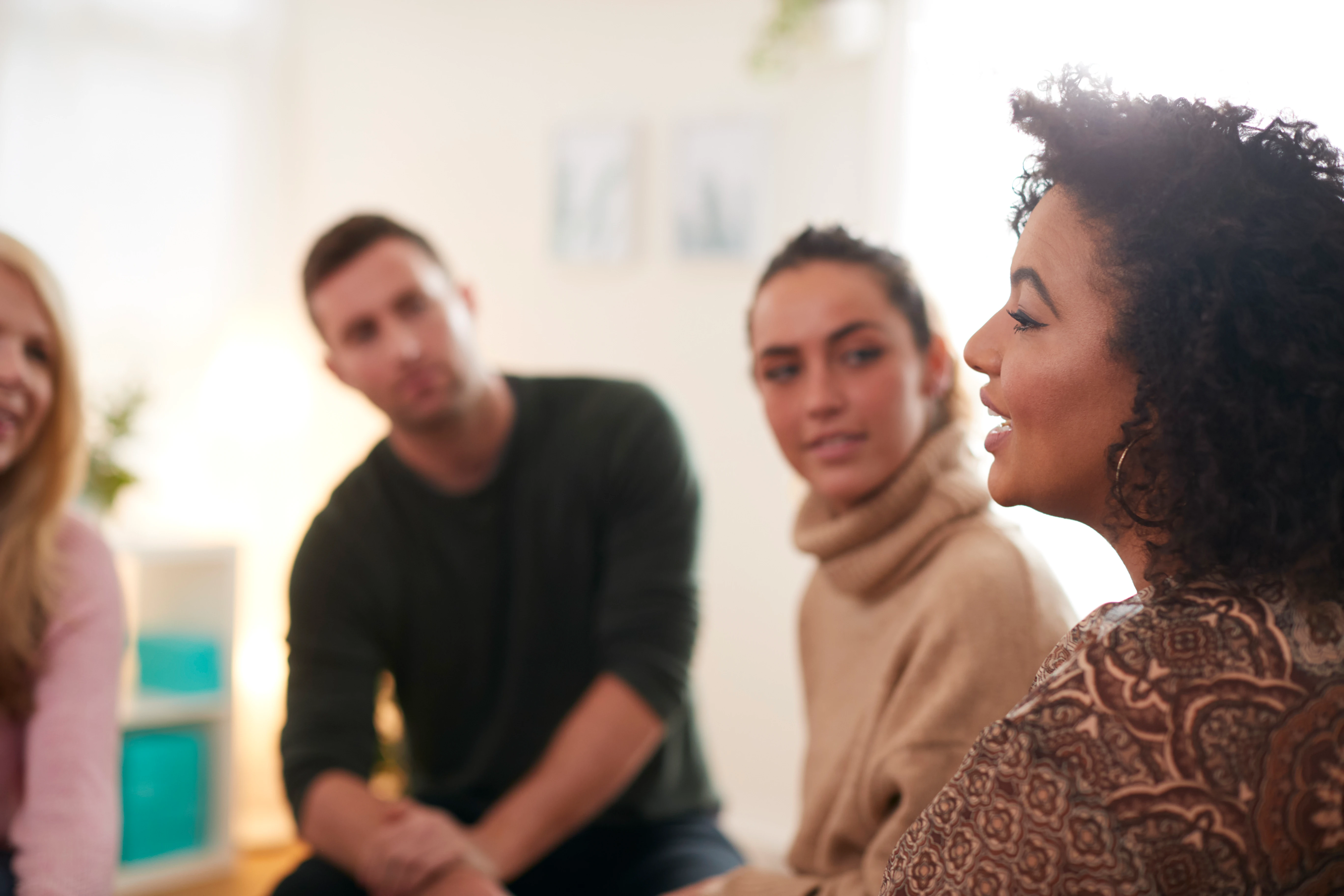 People in an anonymous addiction recovery group meeting.